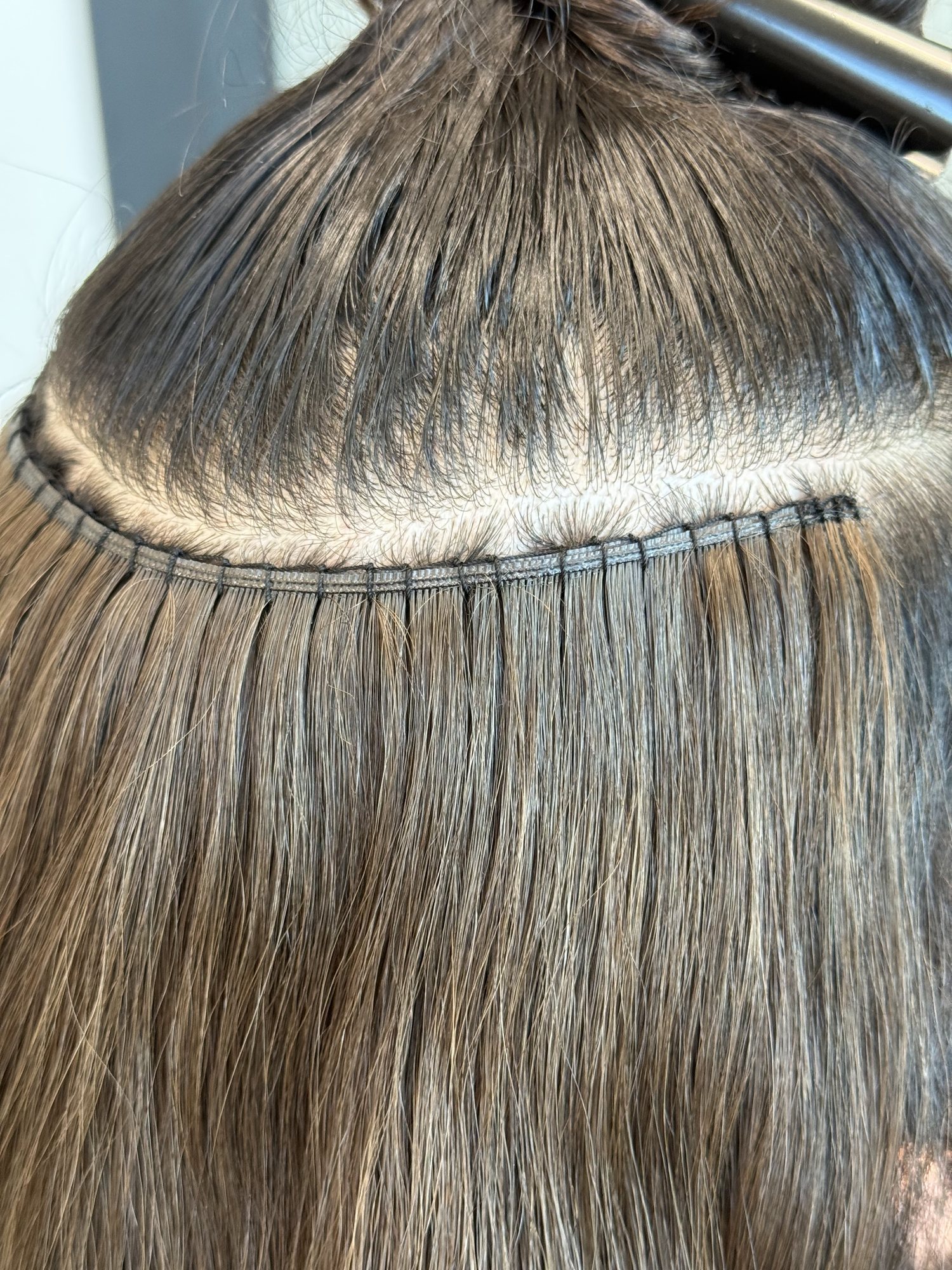 Close-up of an exposed sewn extension row