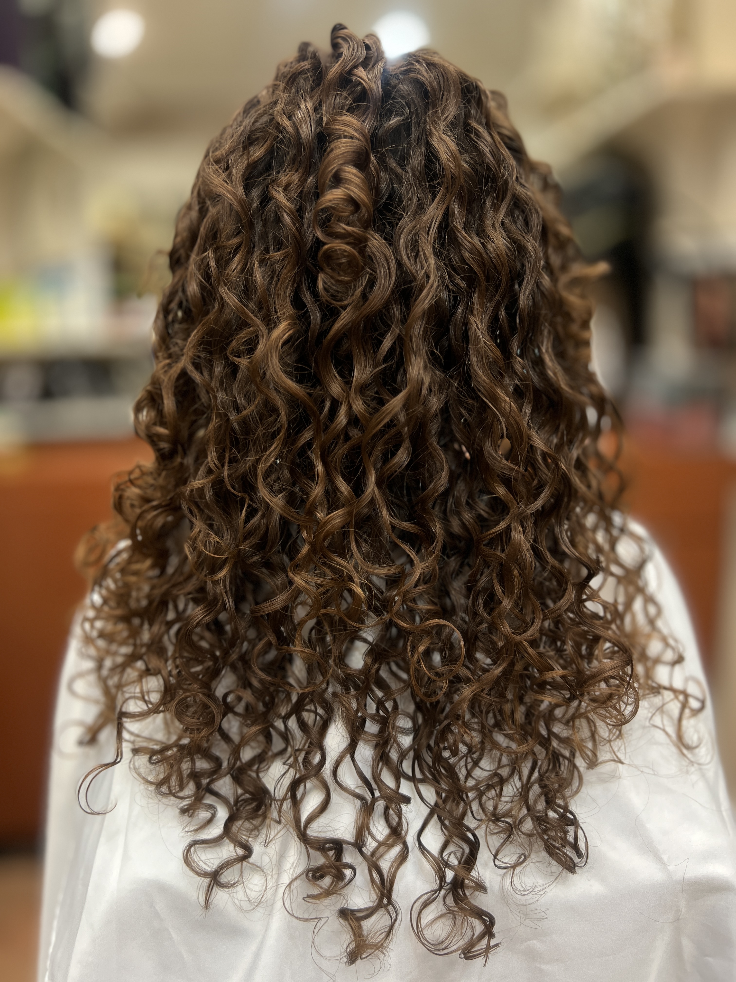 Long auburn curls styled by Rachelle LaNae